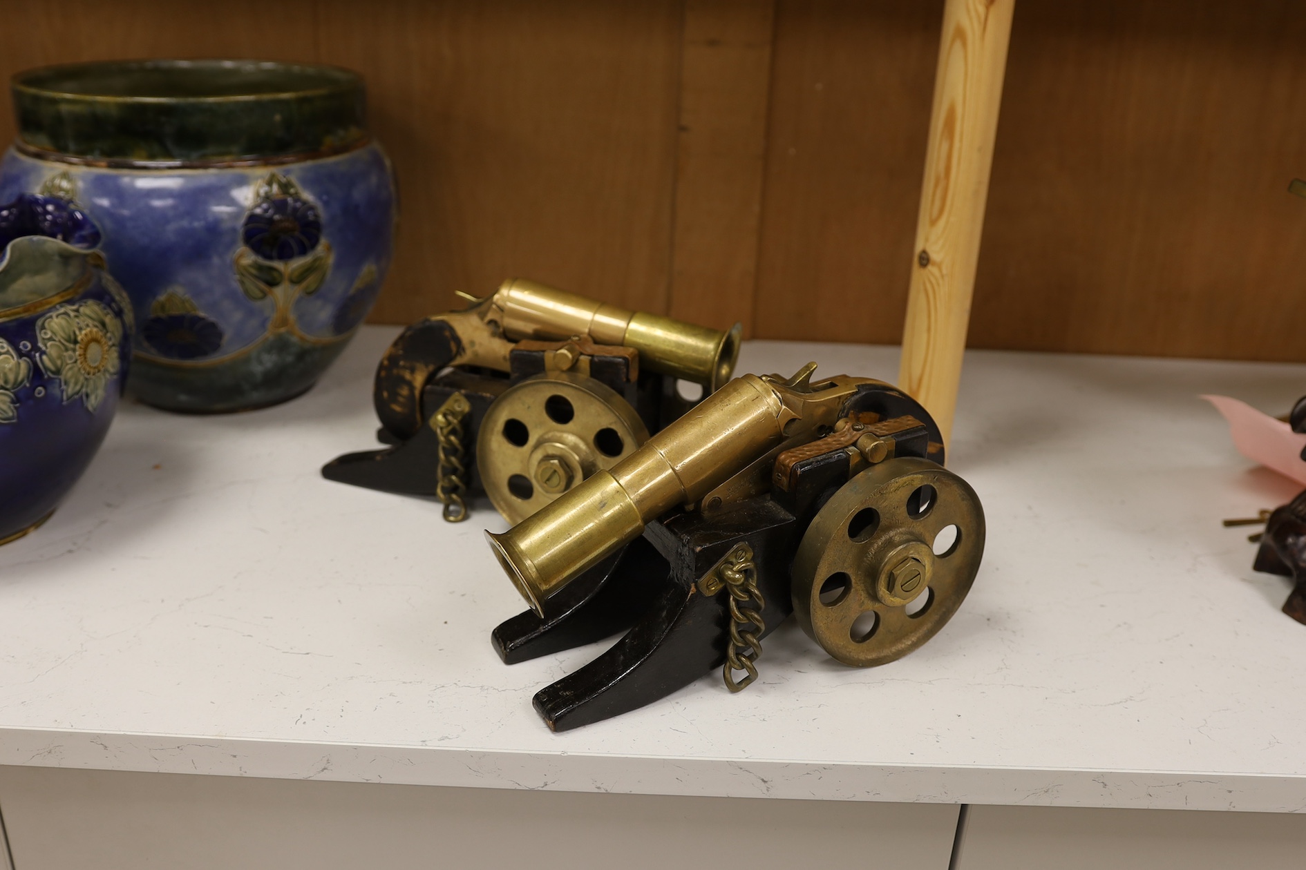 A pair of model bronze and wooden cannons, 27cm long. Condition - worn, strapping rusty